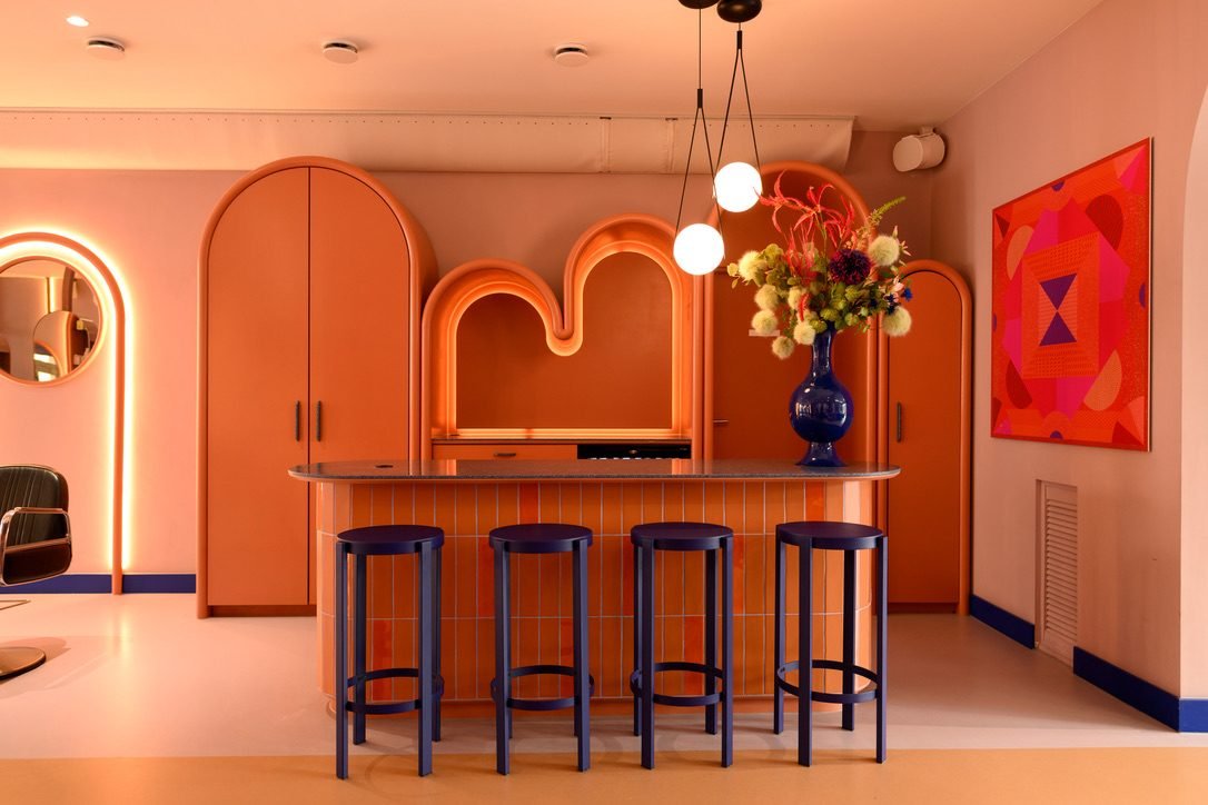 Finished interior with bespoke orange cabinetry and bar seating